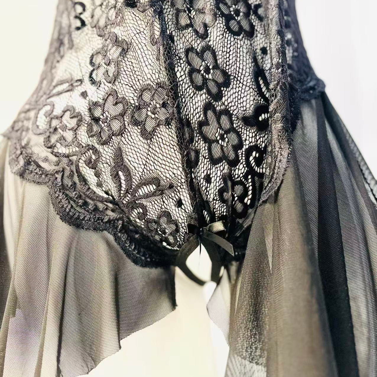 lace edge design detail on black bodysuit showing refined pattern and finish