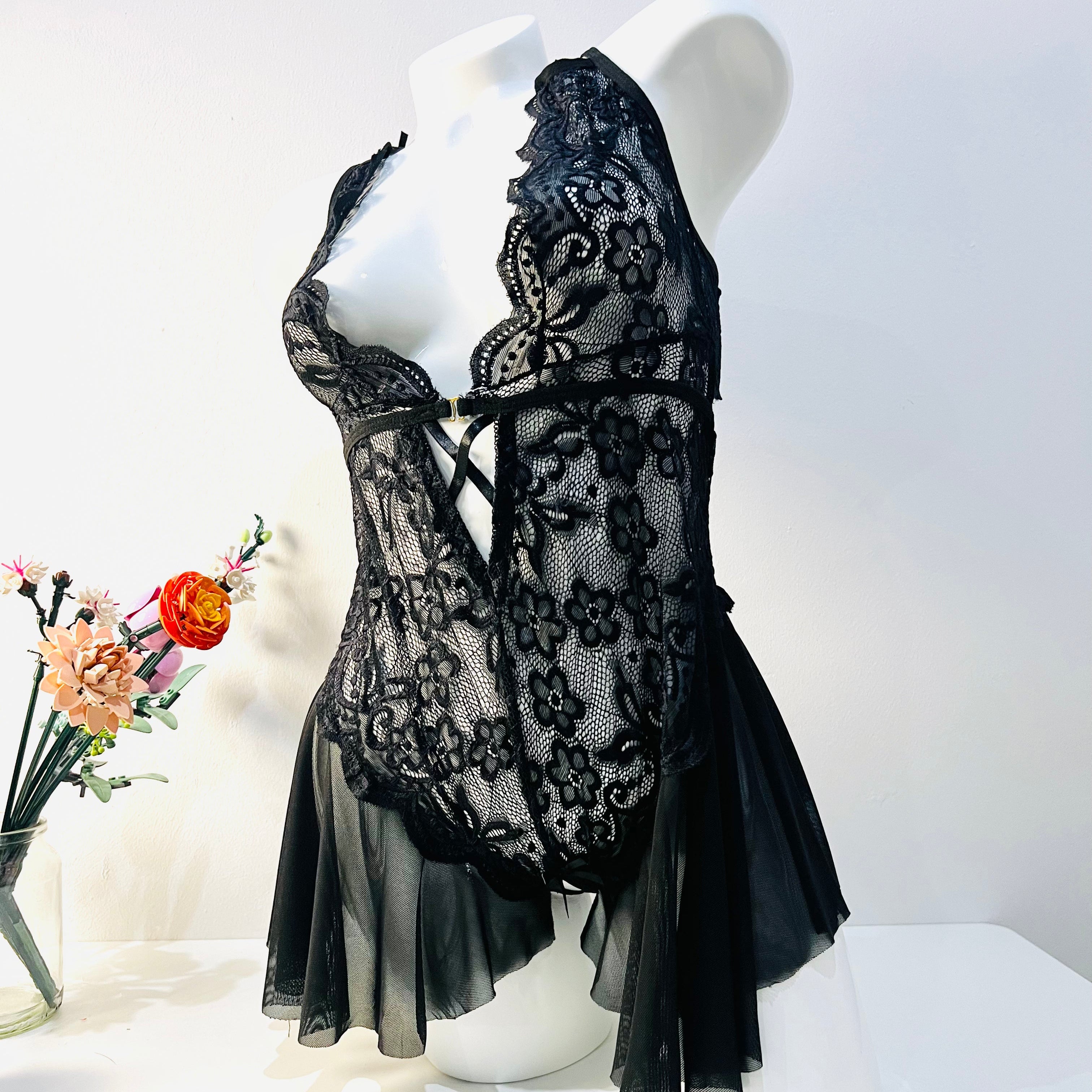 black lace bodysuit worn by model front view elegant and sheer lingerie look