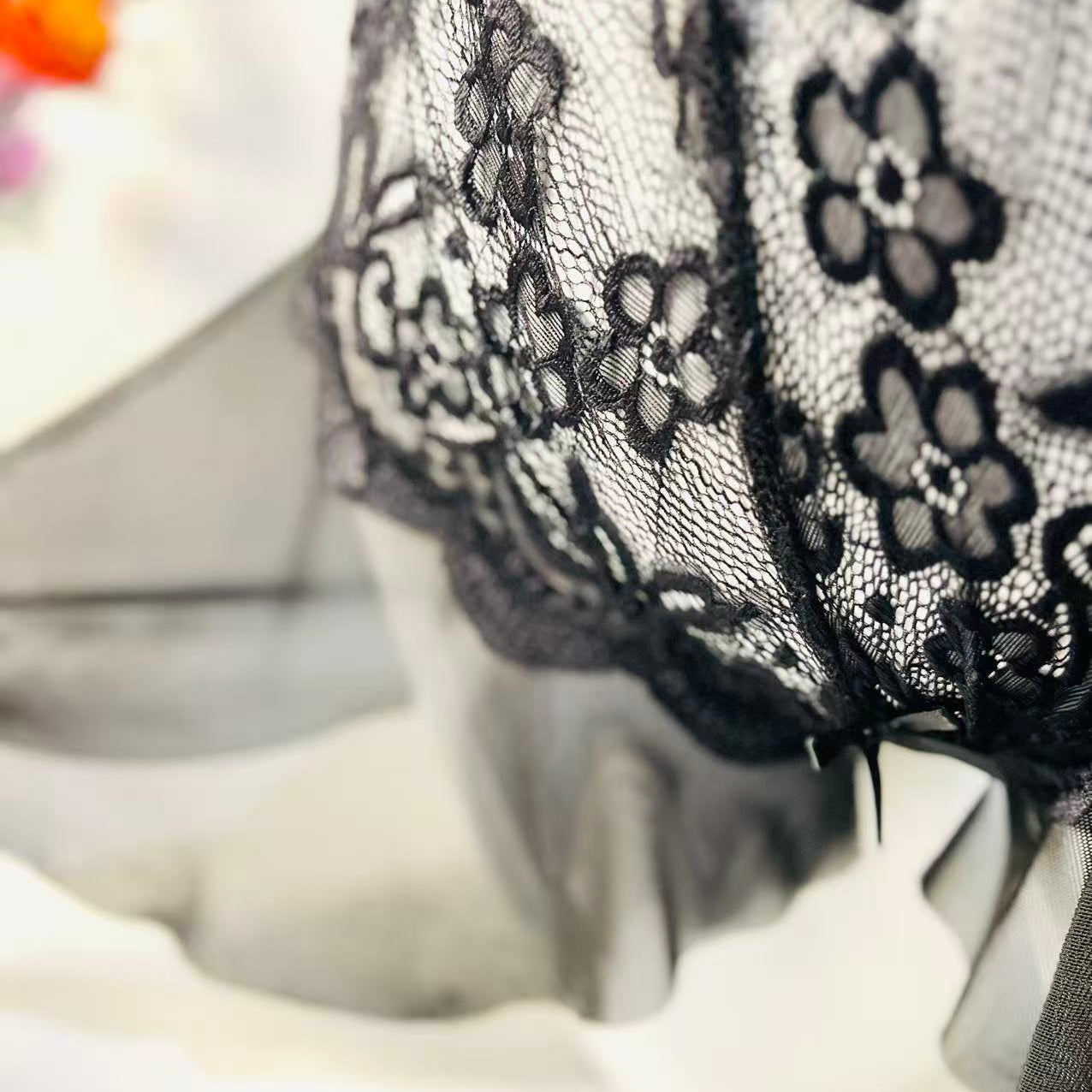 close up of black lace fabric showing soft texture and sheer material detail