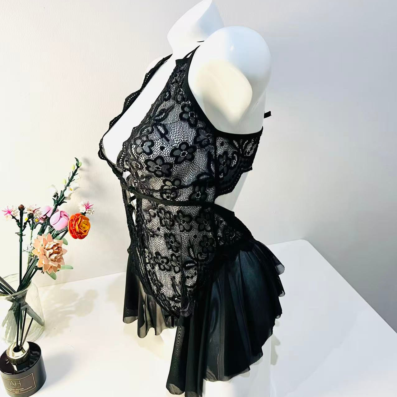 side view of black lace bodysuit highlighting contour fit and body shape