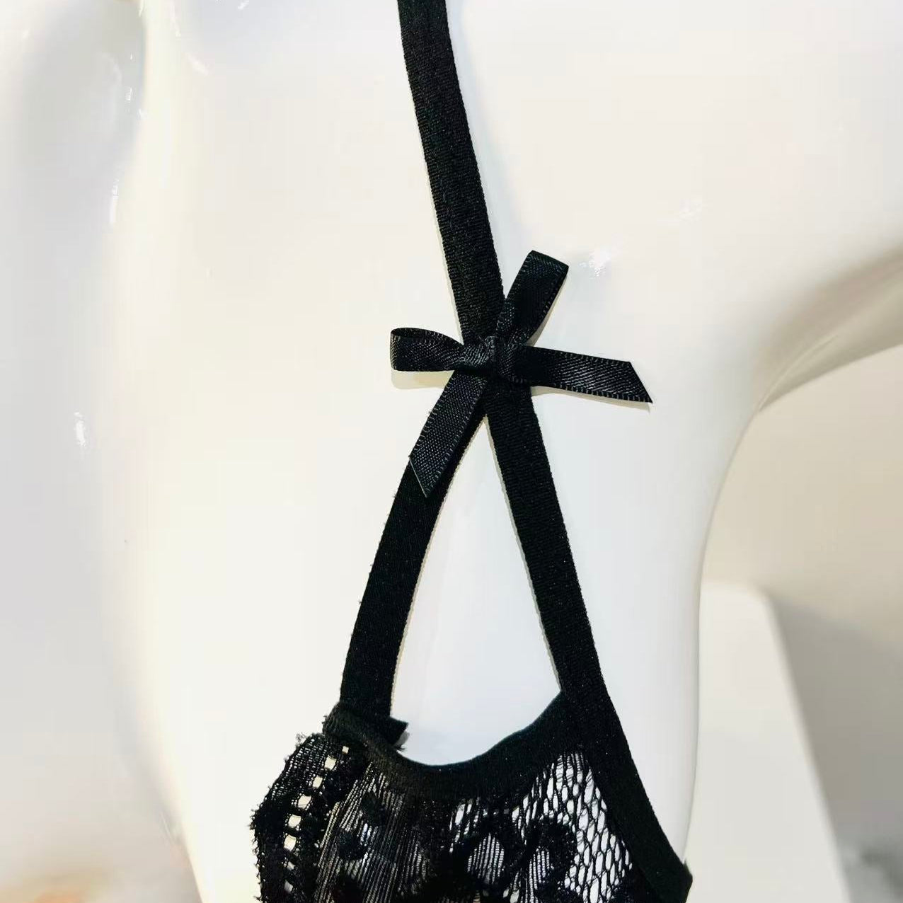 adjustable strap detail on black lace bodysuit showing structure and support