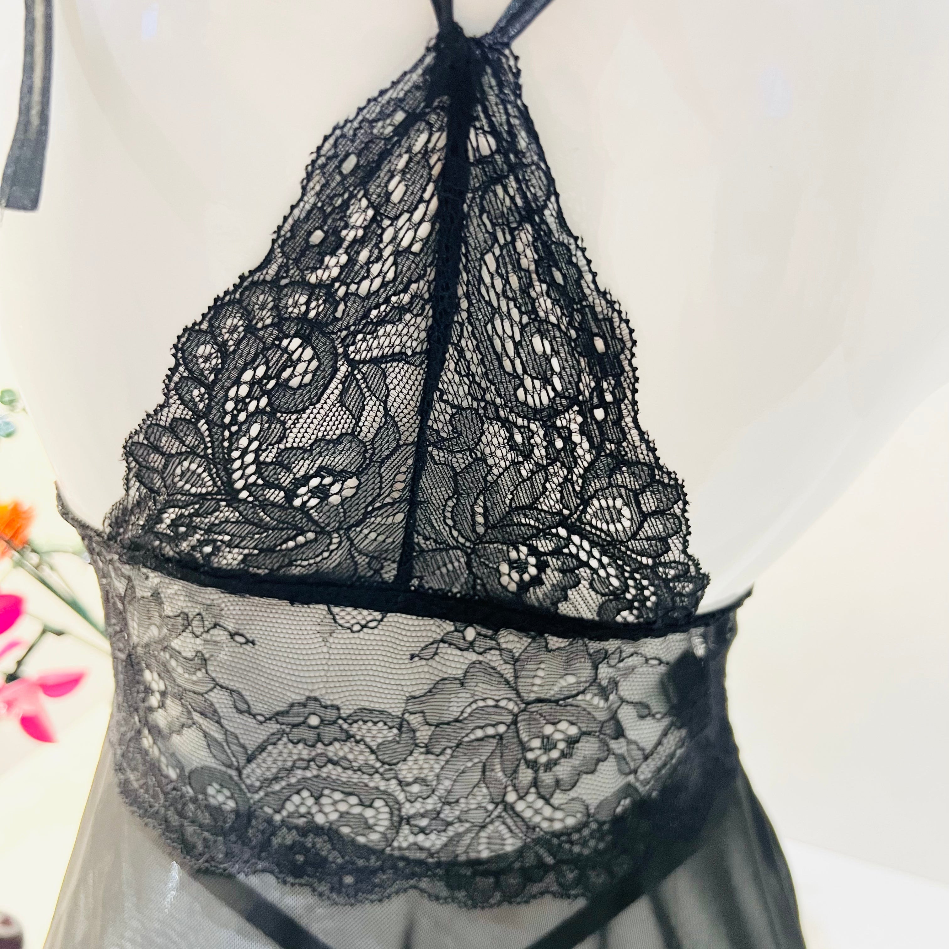 back design detail of black lace sleep dress with fine lace and strap finish
