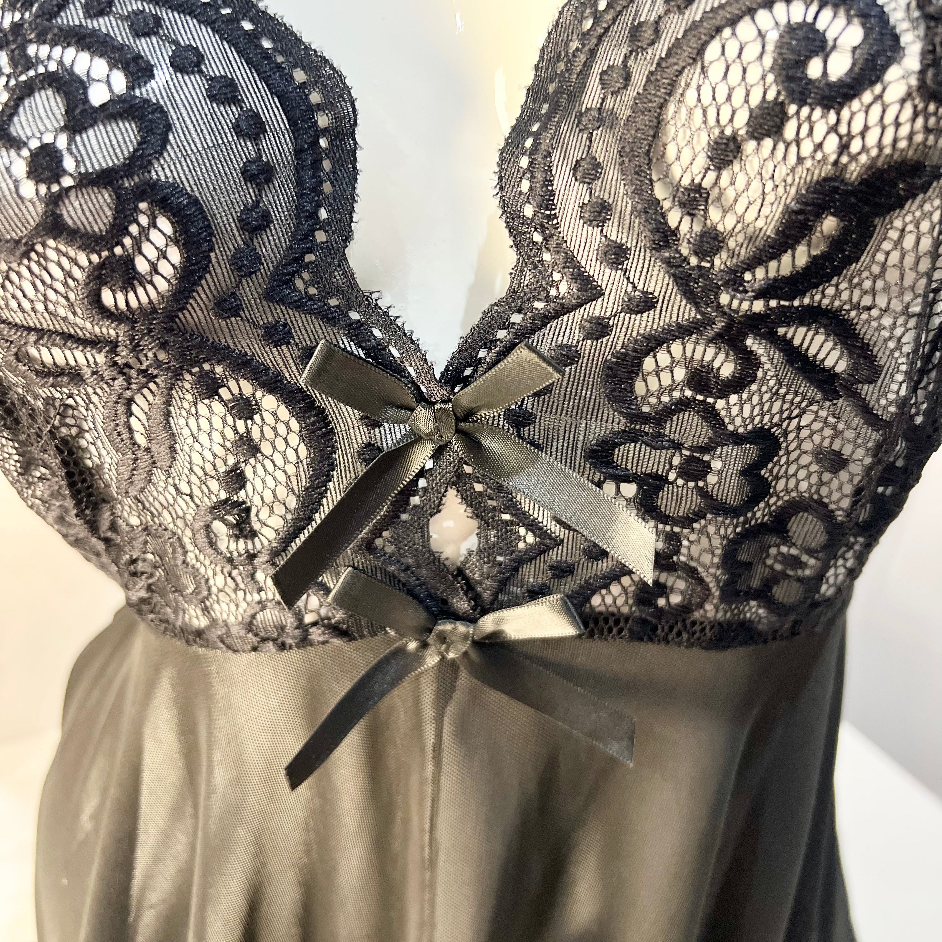 lace detail on bust area of black sleep dress showing delicate embroidery texture