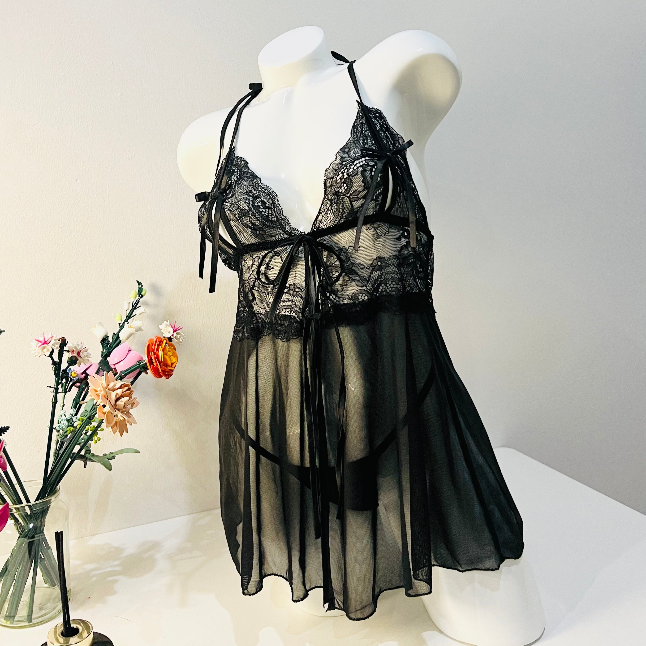 black lace sleep dress worn by model front view elegant and minimal lingerie look