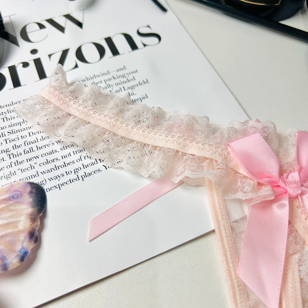 pink lace bow thong lingerie lace fabric close up texture detail
