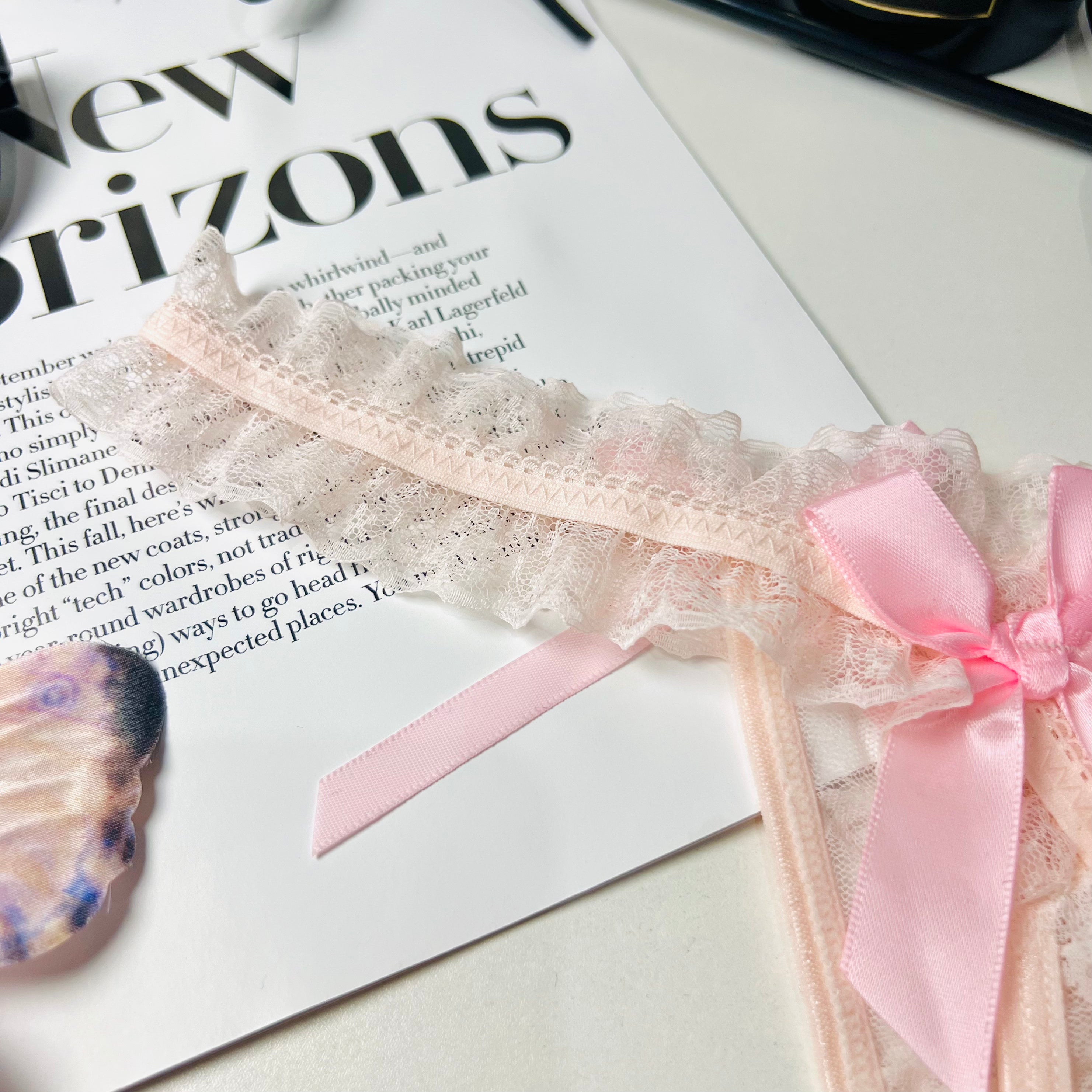 pink lace bow thong lingerie lace fabric close up texture detail