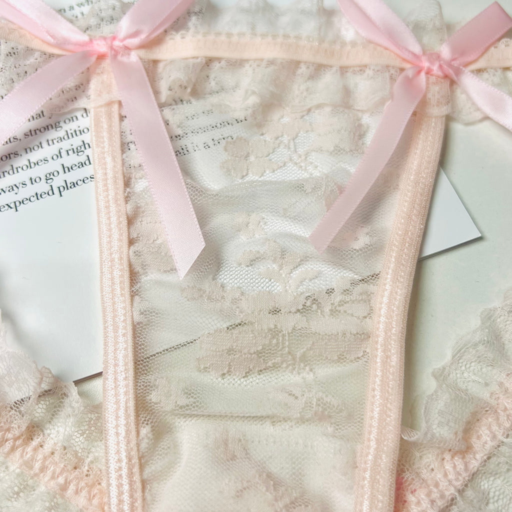 pink lace bow thong lingerie front lace detail close up texture