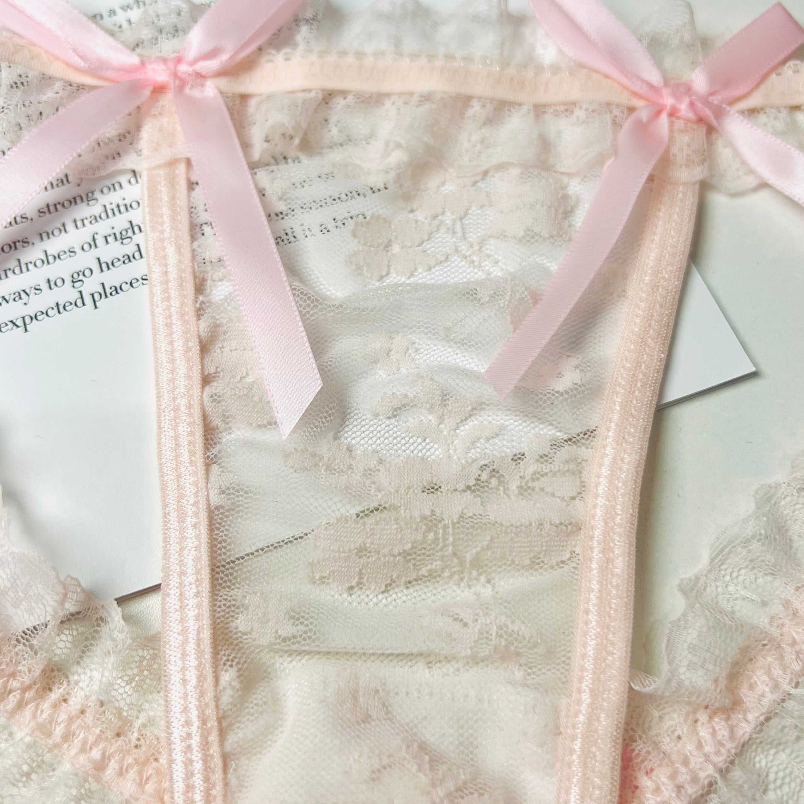 pink lace bow thong lingerie front lace detail close up texture
