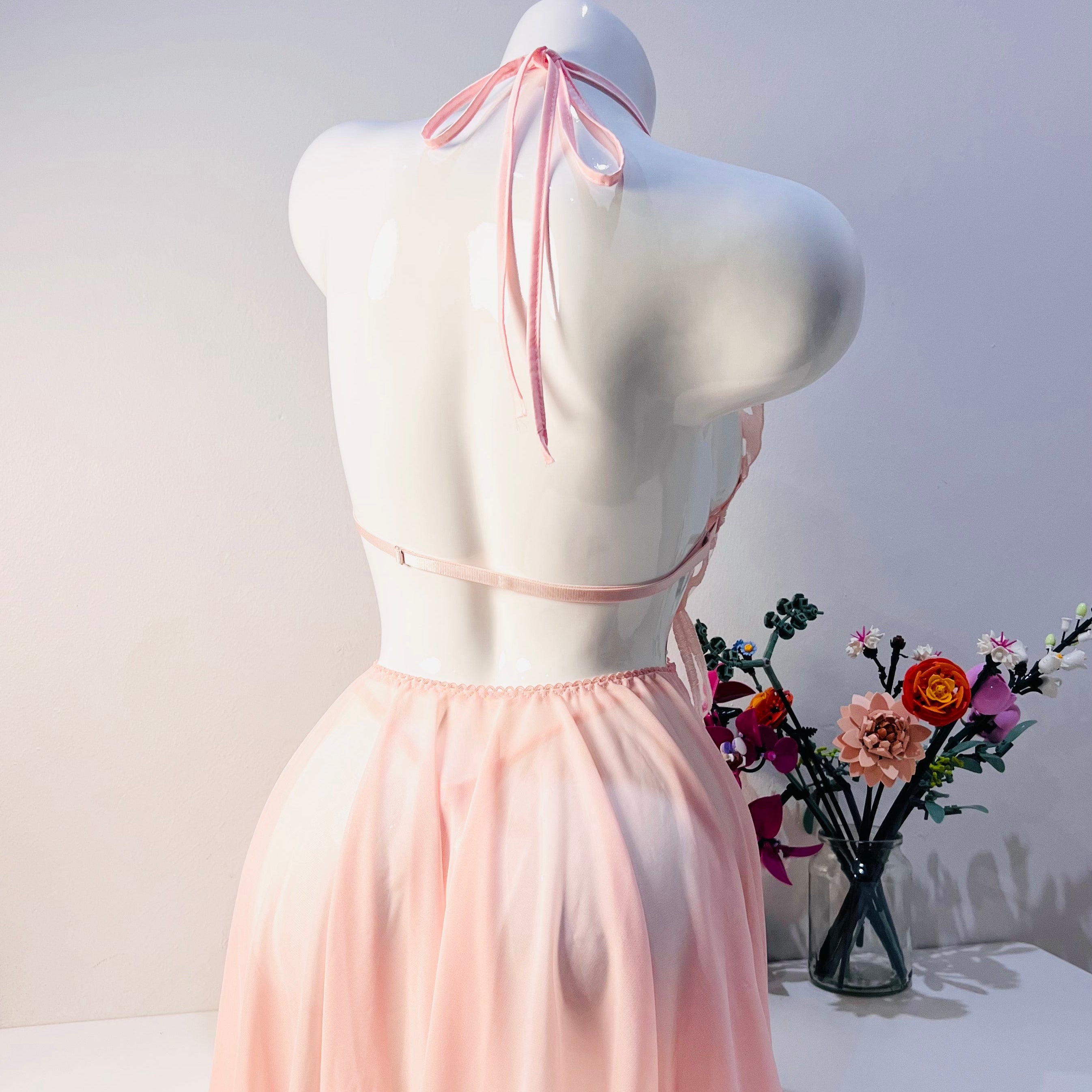 pink lace sleep dress back view highlighting smooth silhouette and thong style