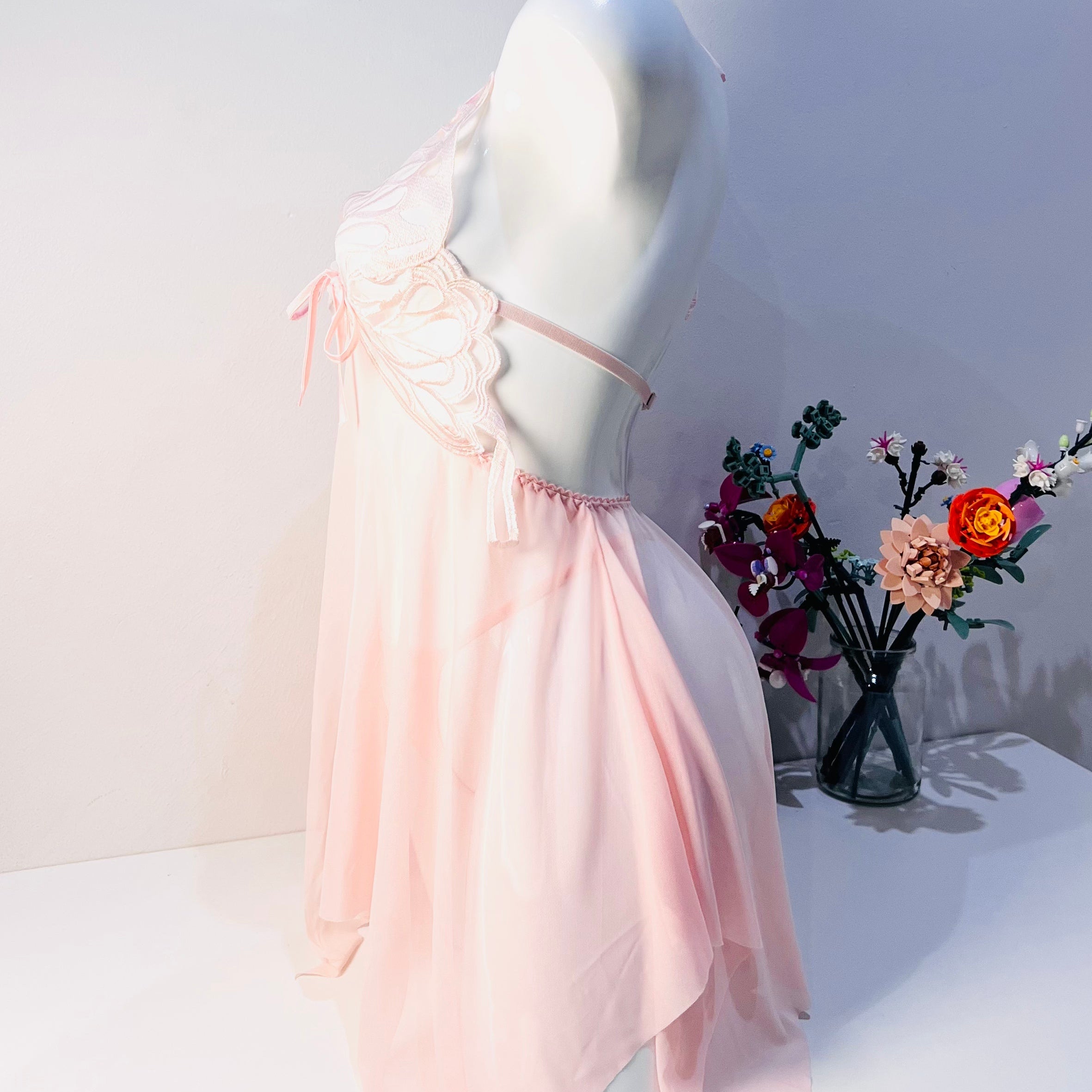 side view of pink lace sleep dress showing gentle flow and flattering body fit