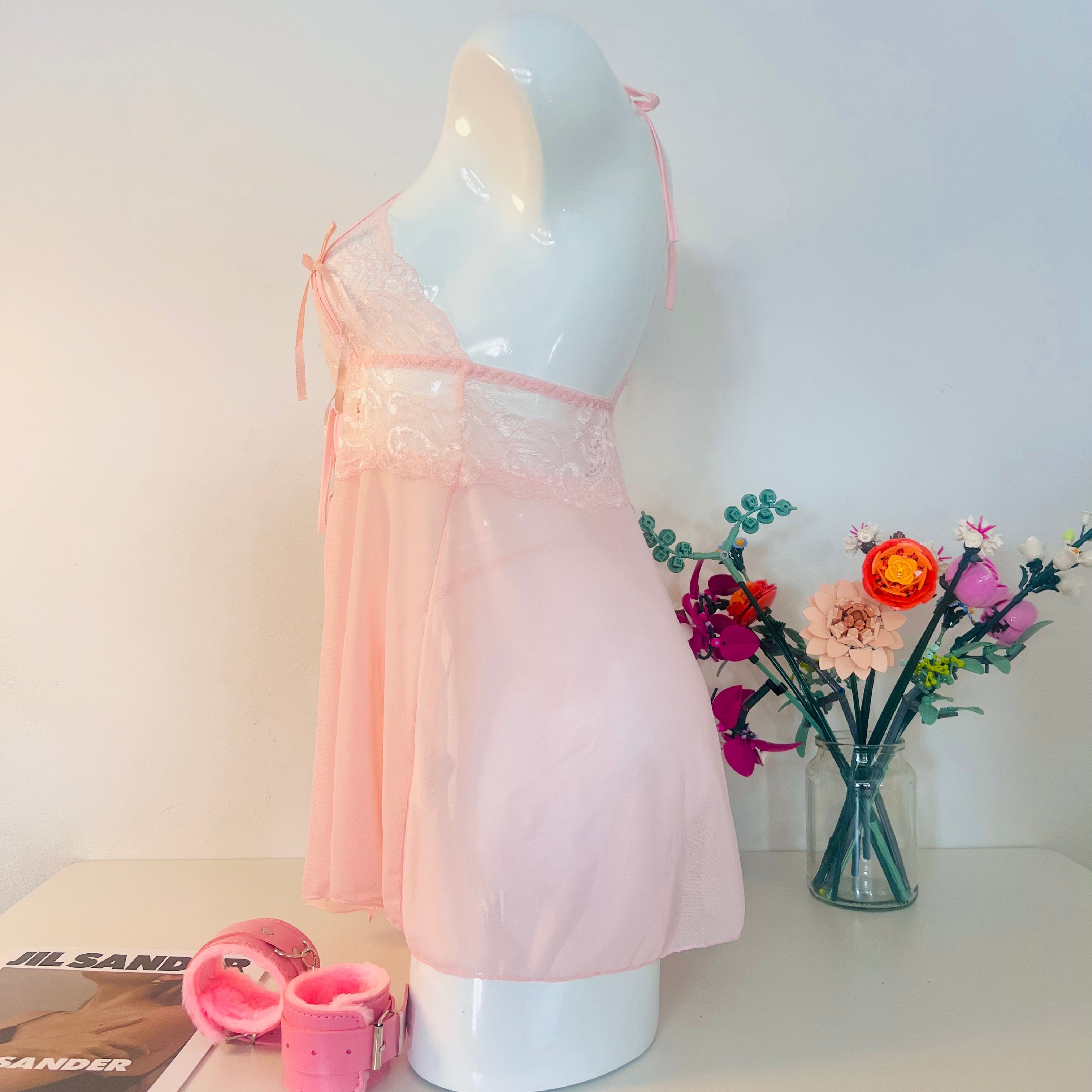 pink lace sleep dress side view showing soft silhouette and body fit