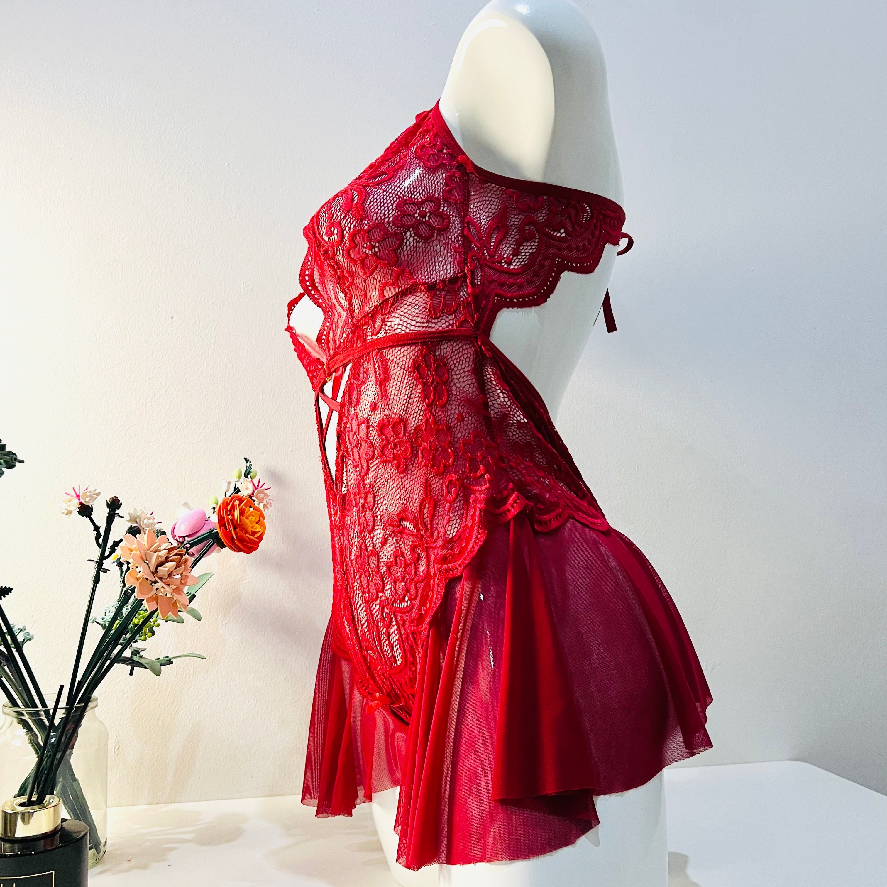 side view of red lace bodysuit highlighting body curve and fitted shape