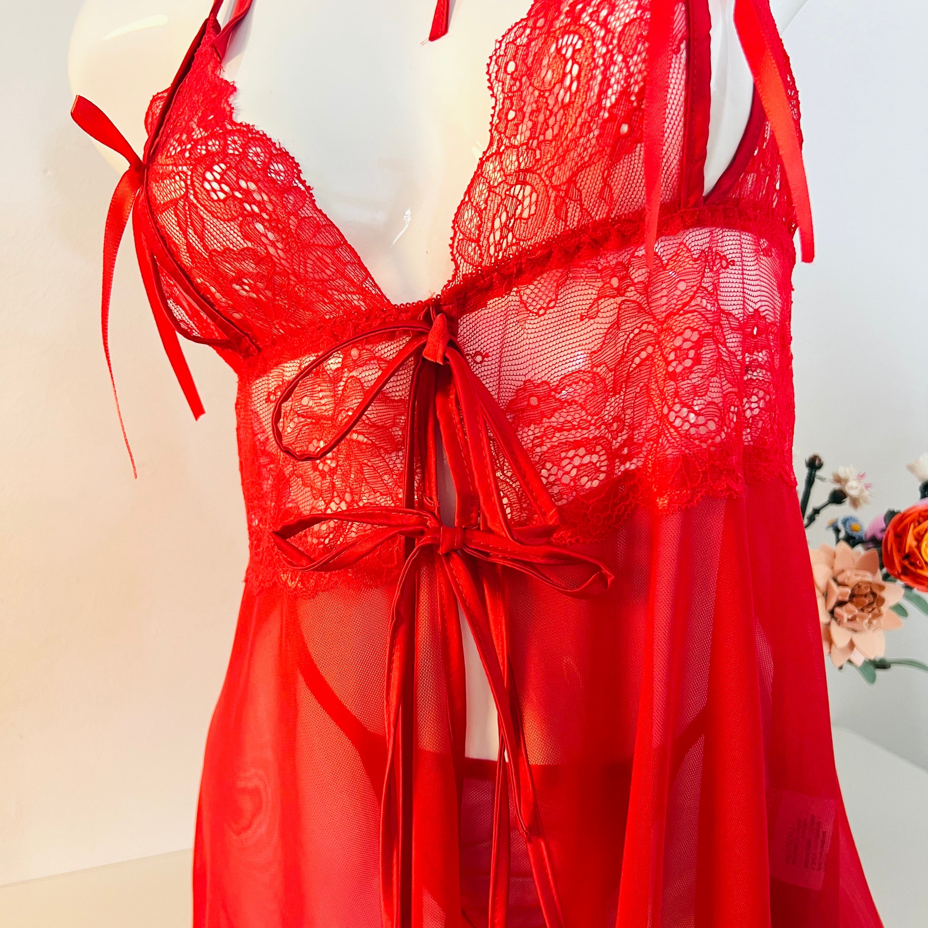 close up lace embroidery on bust area showing delicate red floral texture