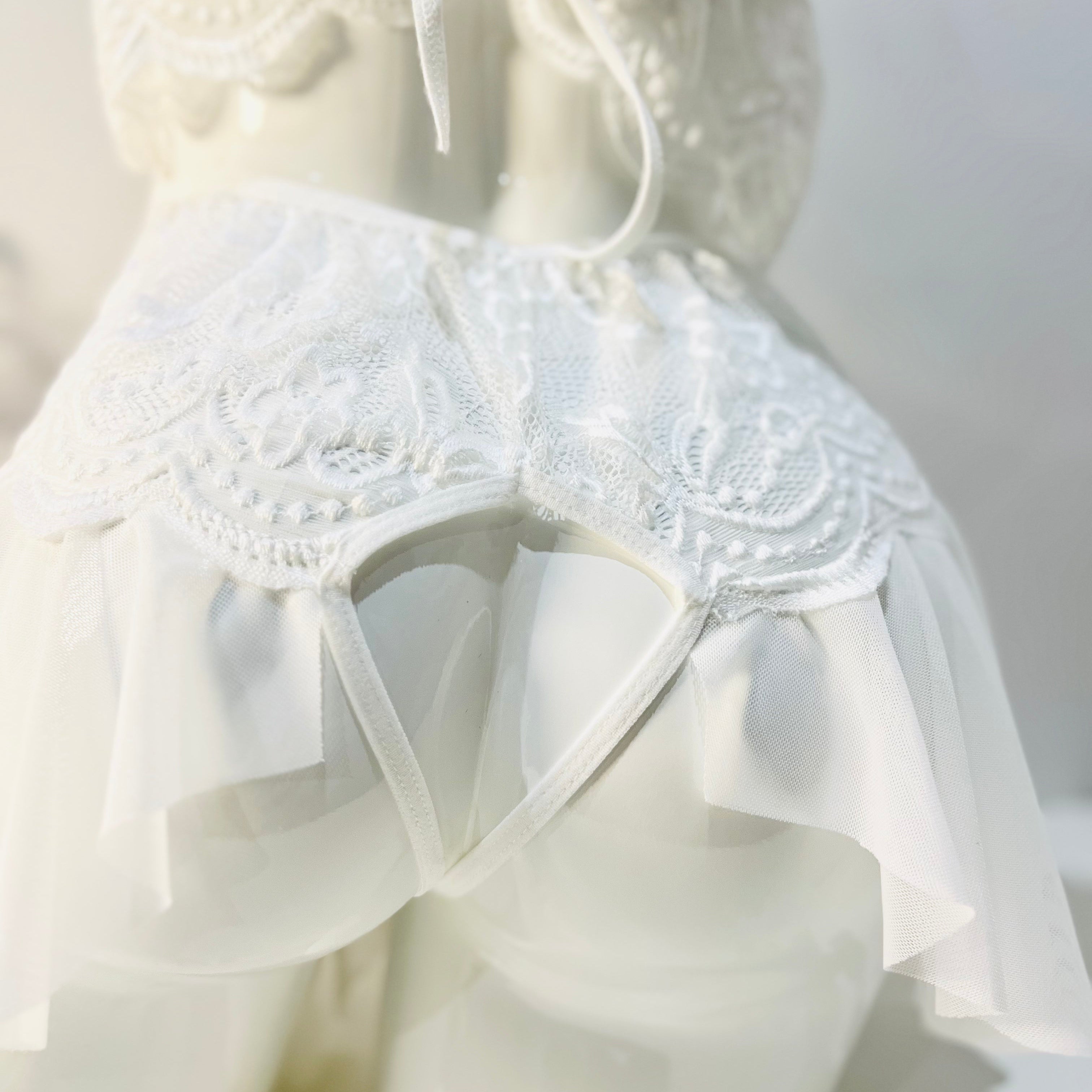 back cut detail of white lace bodysuit highlighting shape and contour fit