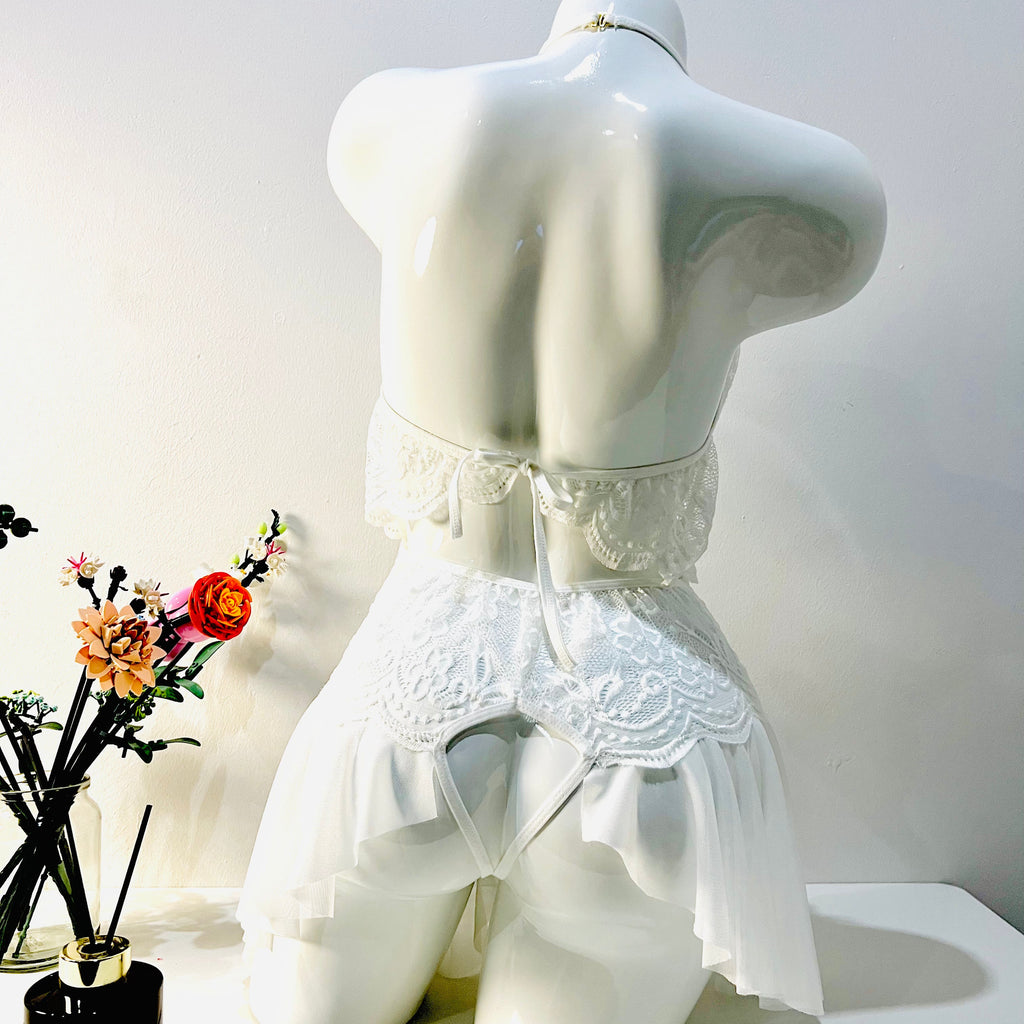 white lace bodysuit back view highlighting smooth silhouette and sheer design